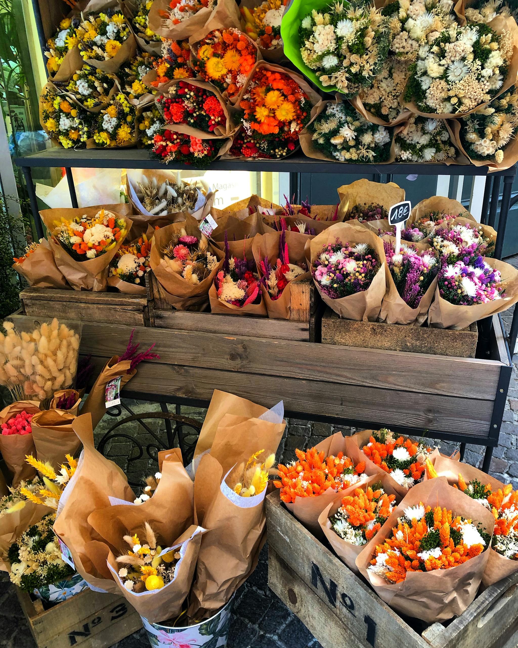 Colorful flower bouquets displayed outdoors in Antibes market, perfect for spring decor.